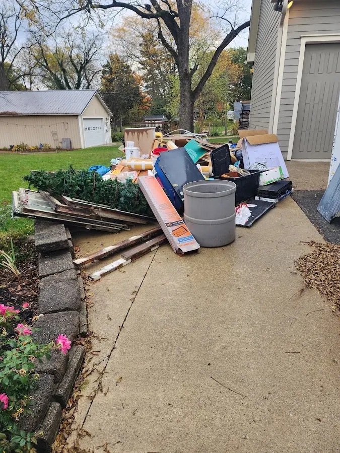 Dumpster being loaded with debris for Estate Cleanout Dumpster Rental in Marshalltown
